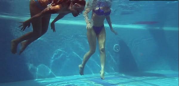  Two hot lesbian brunettes in the swimming pool